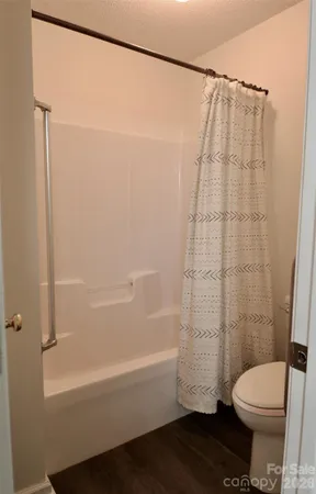 a bathroom with a toilet and a bathtub