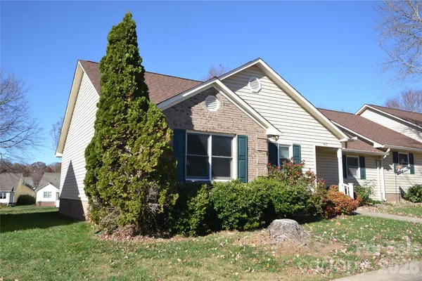 a front view of a house with a garden and plants