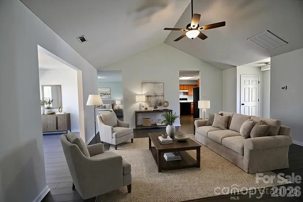 a living room with furniture ceiling fan and a rug