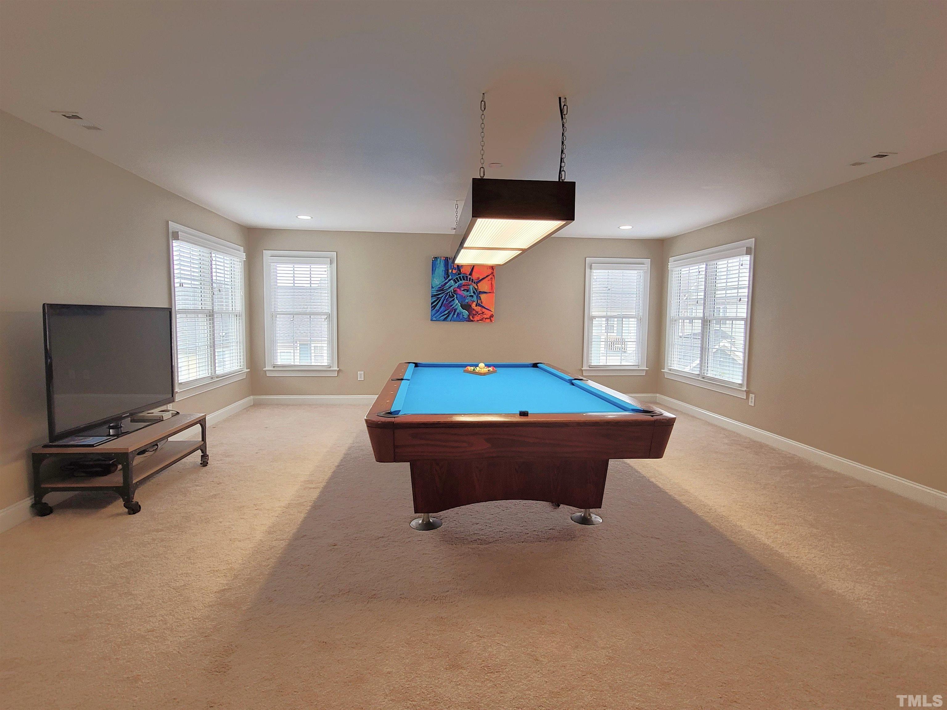 411 Magdala Place Apex, NC 27502 - Photo 11 of 29 a room with pool table flat screen tv and windows