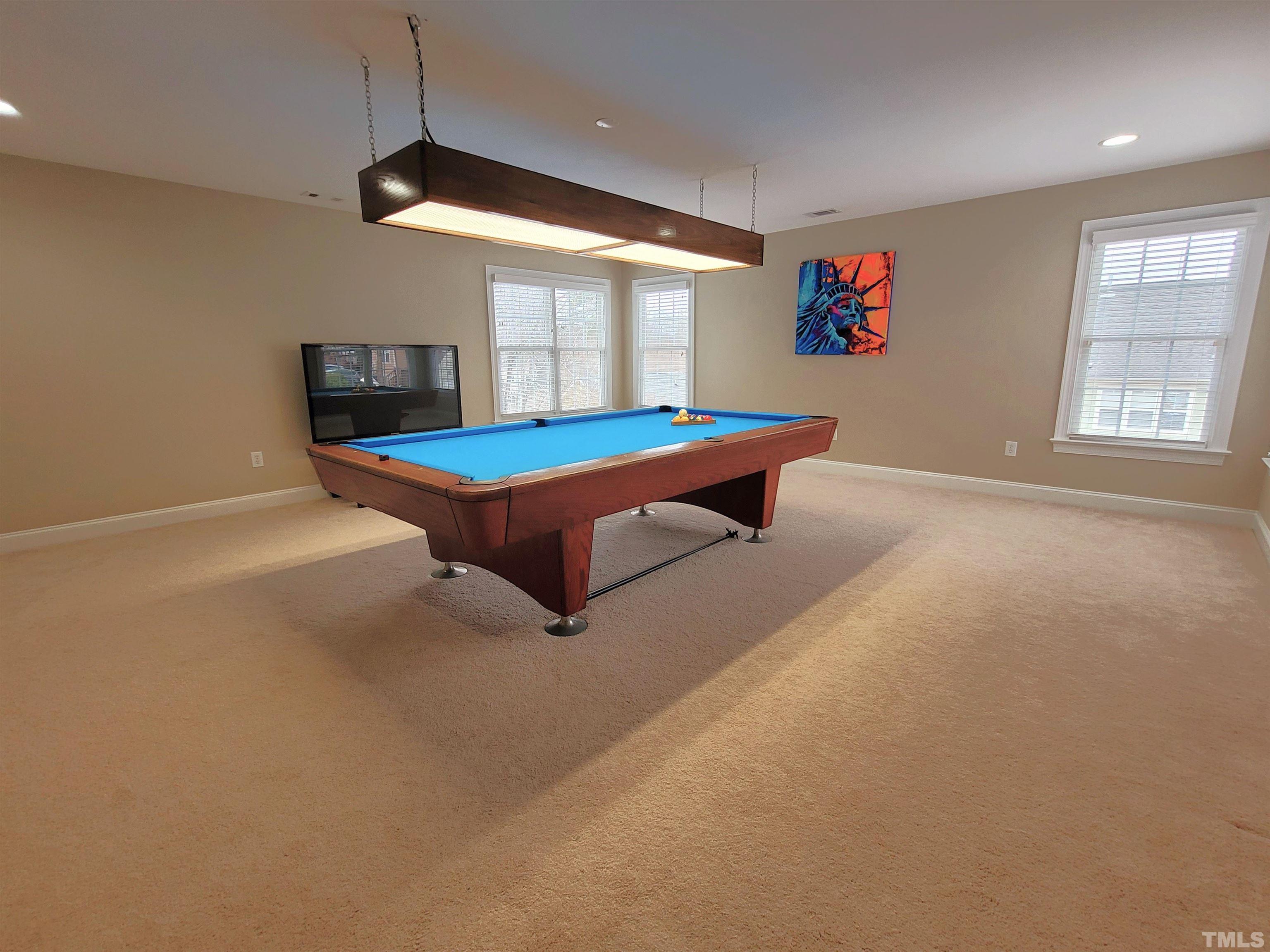 411 Magdala Place Apex, NC 27502 - Photo 12 of 29 a room with pool table and windows