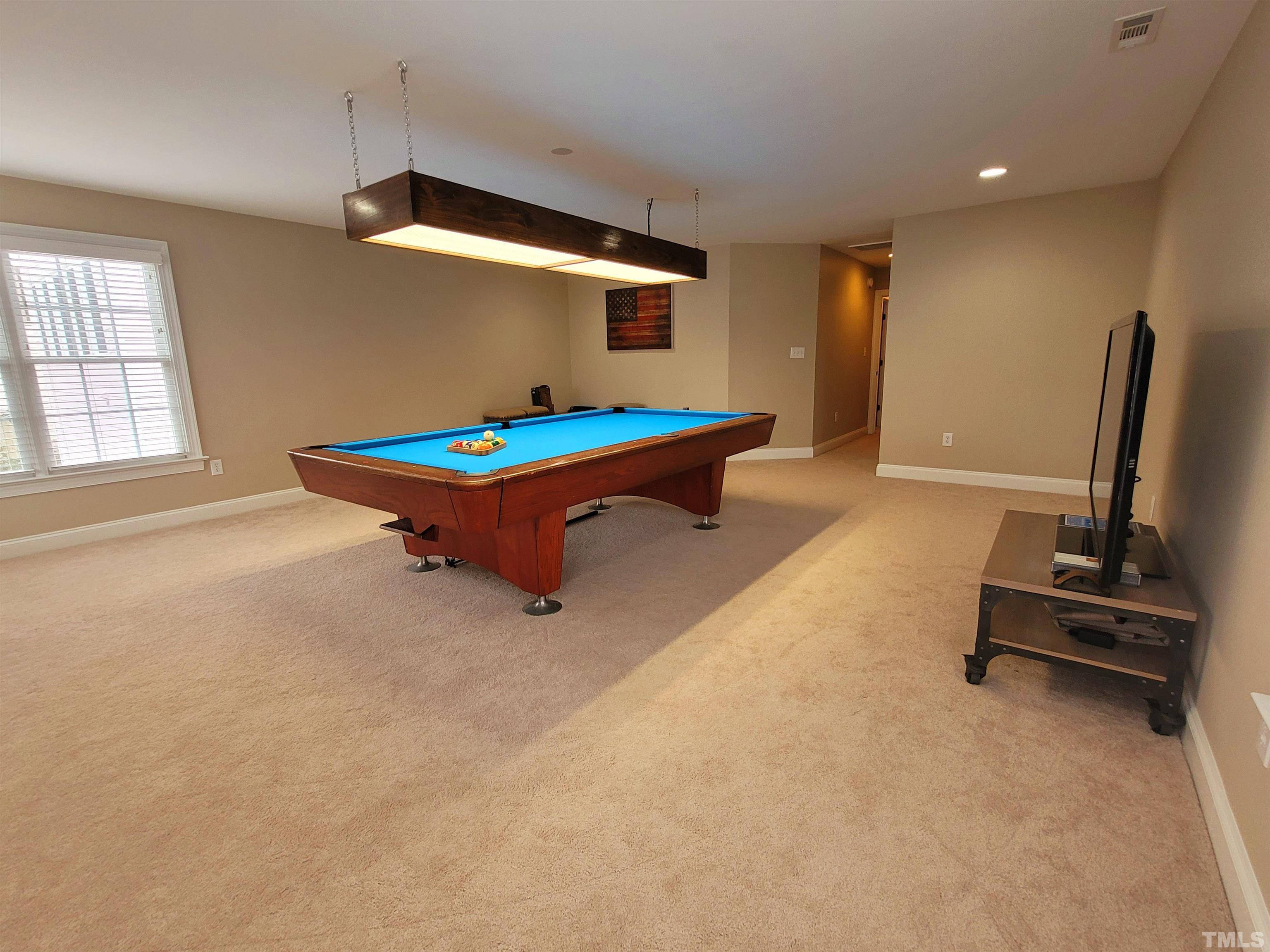 411 Magdala Place Apex, NC 27502 - Photo 13 of 29 a living room with pool table and gym equipment