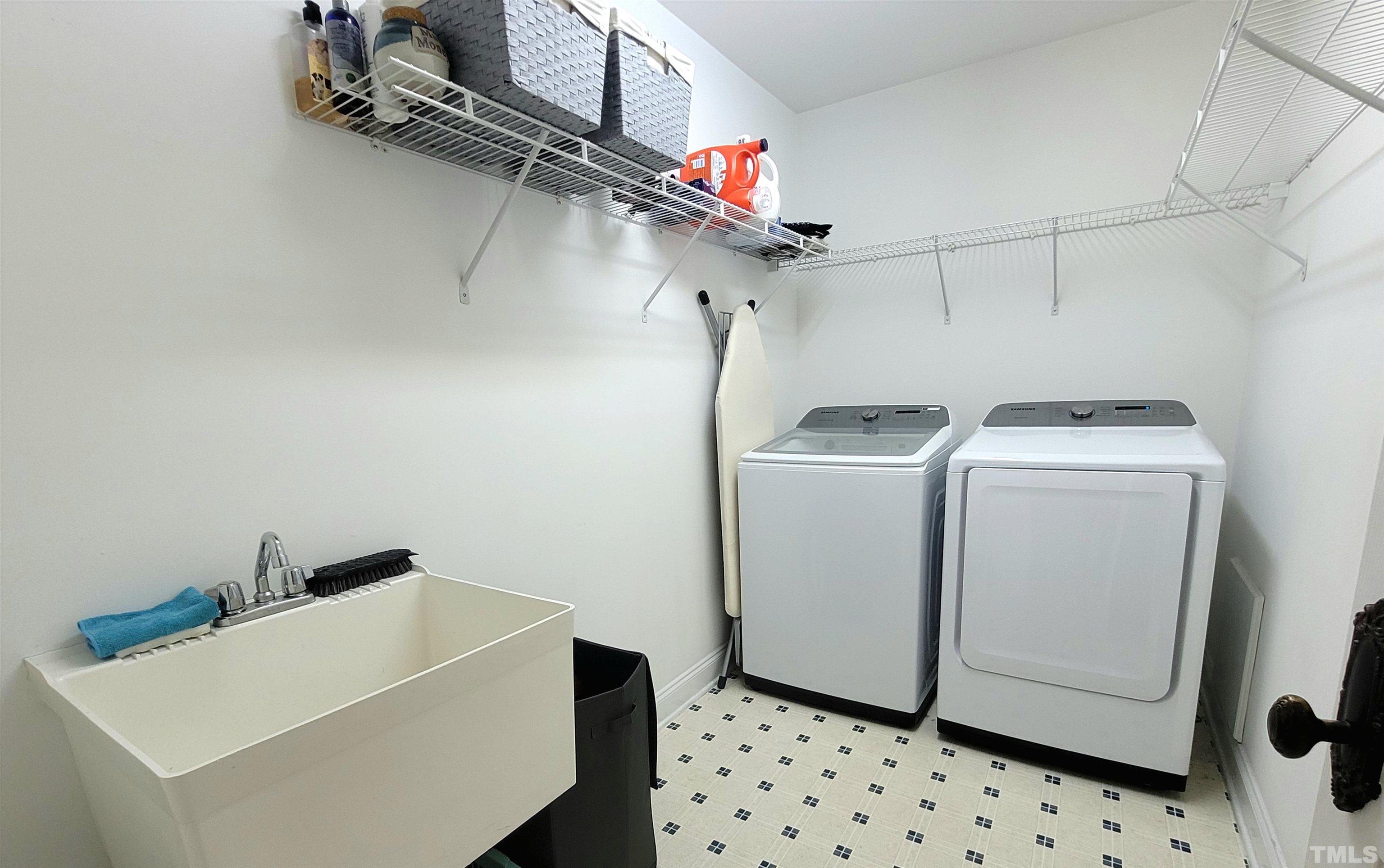 411 Magdala Place Apex, NC 27502 - Photo 14 of 29 a utility room with dryer and washer
