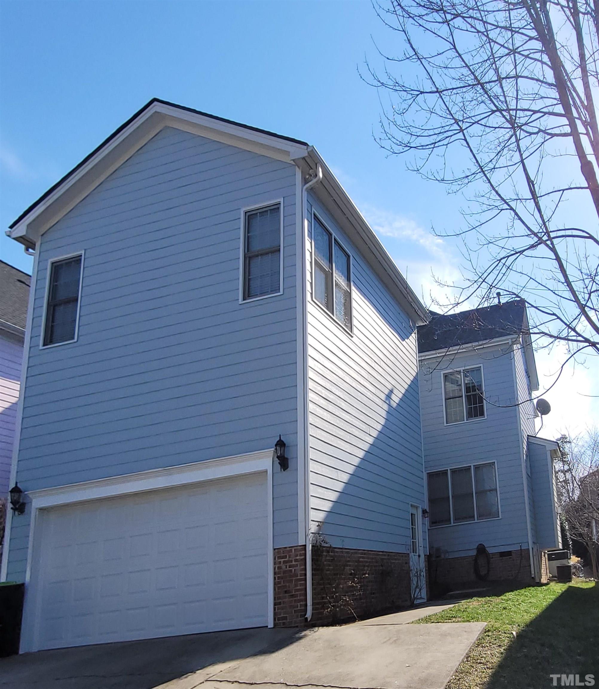411 Magdala Place Apex, NC 27502 - Photo 2 of 29 a front view of a house with a yard