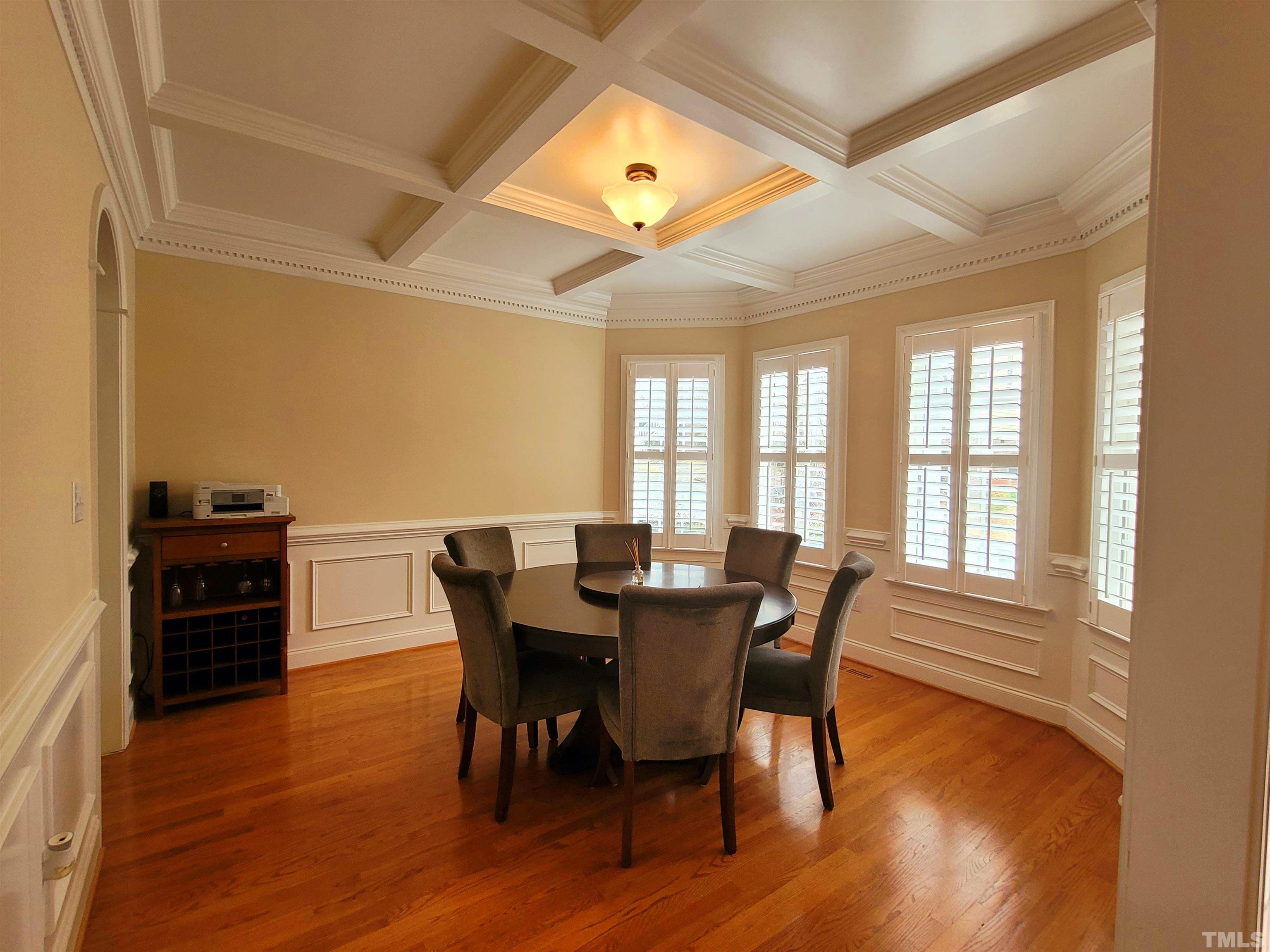 411 Magdala Place Apex, NC 27502 - Photo 25 of 29 a view of a dining room with furniture and wooden floor