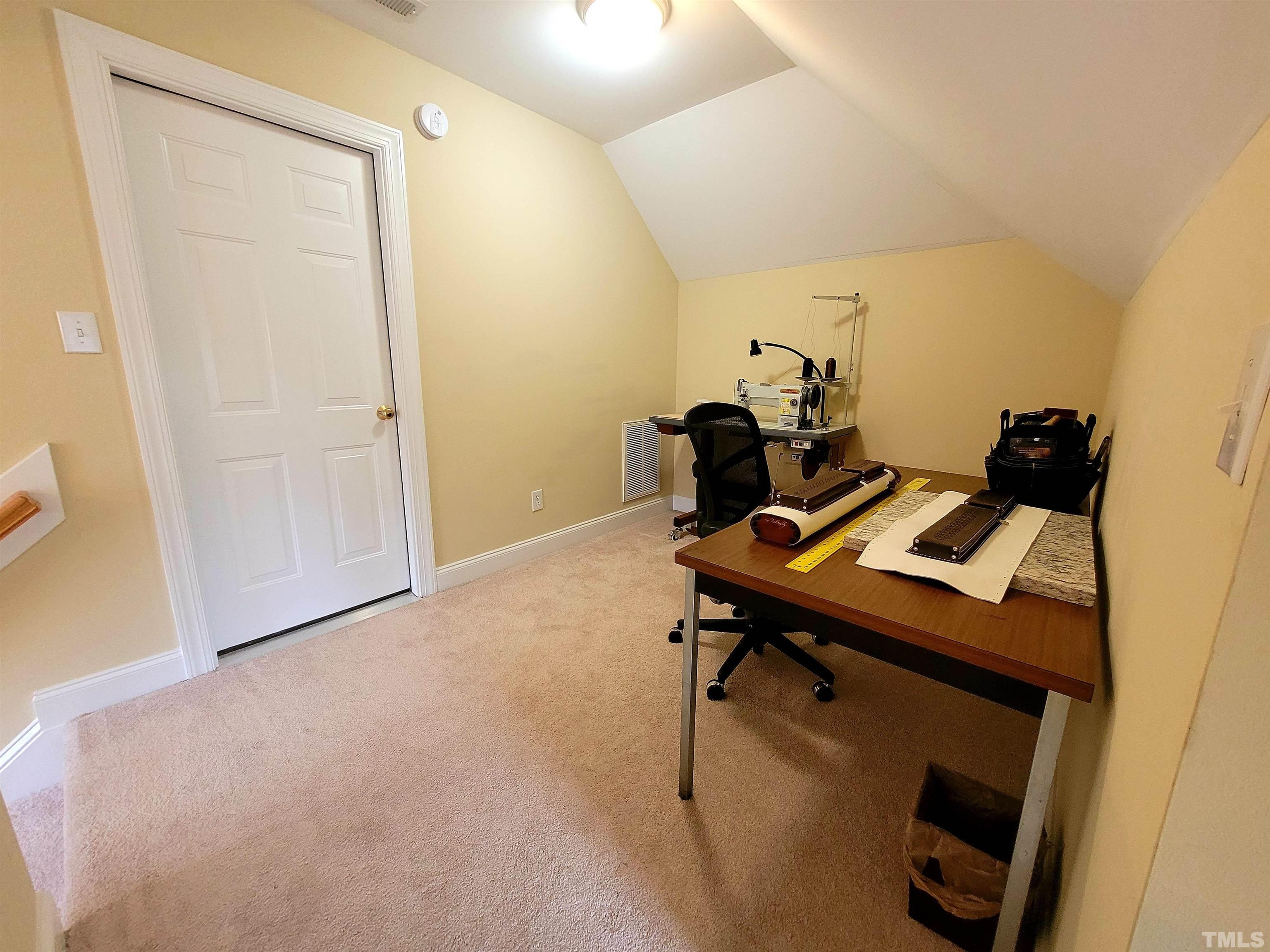 411 Magdala Place Apex, NC 27502 - Photo 7 of 29 a view of a workspace with furniture and a window
