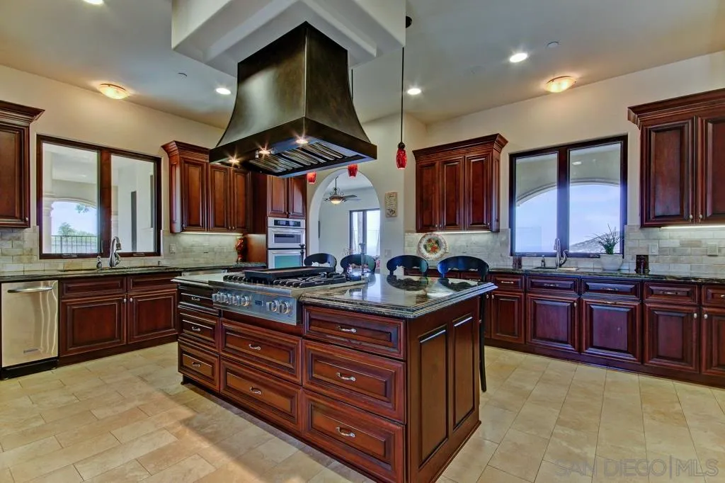 15362 Skyridge Road Poway, CA 92064 - Photo 8 of 24 a kitchen with stainless steel appliances granite countertop a stove a sink dishwasher and a refrigerator