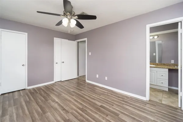 a view of an empty room and kitchen view