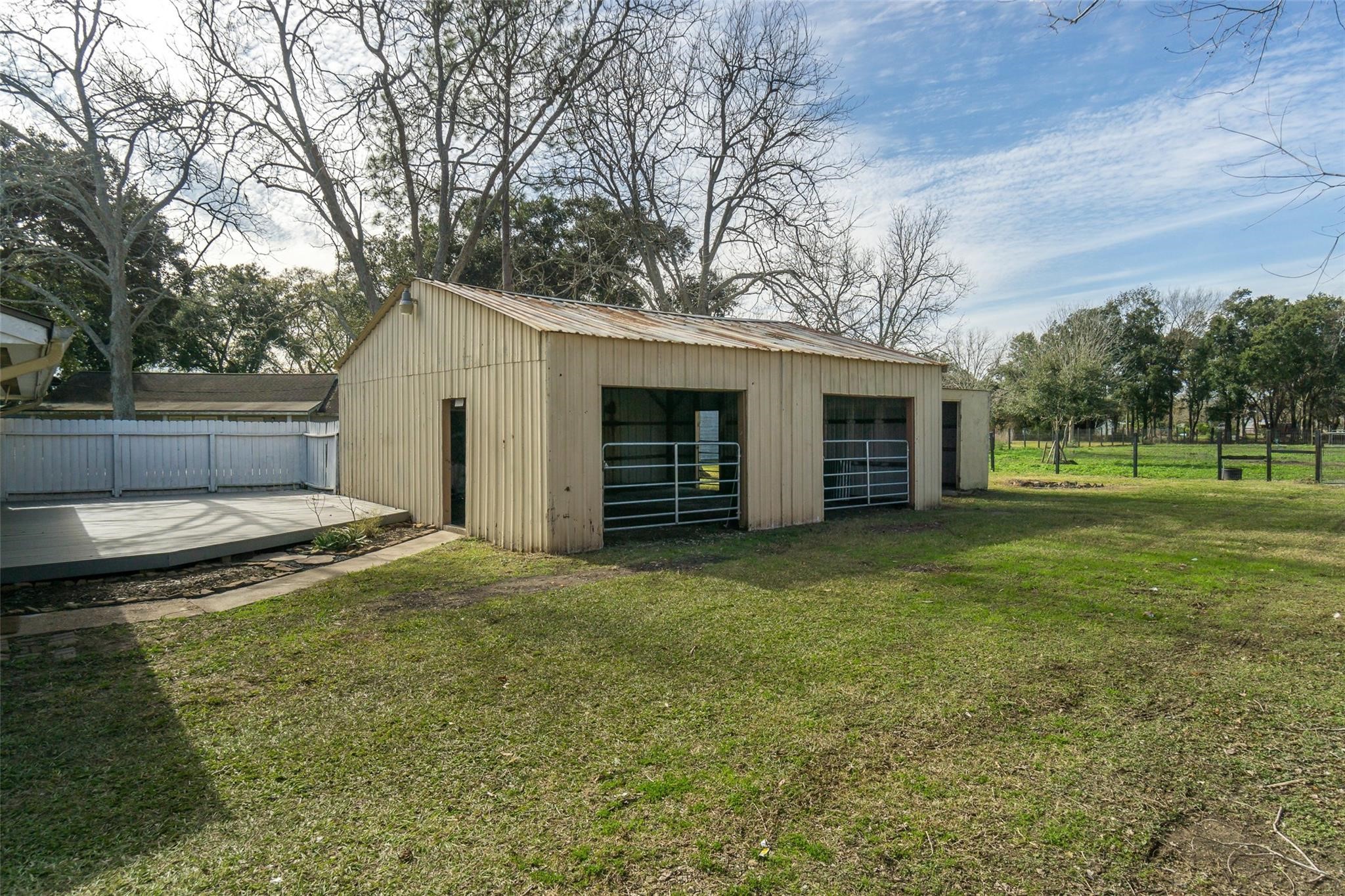 4604 South Tower Road Santa Fe, TX 77517 - Photo 19 of 28 a backyard of a house with large trees and barbeque oven