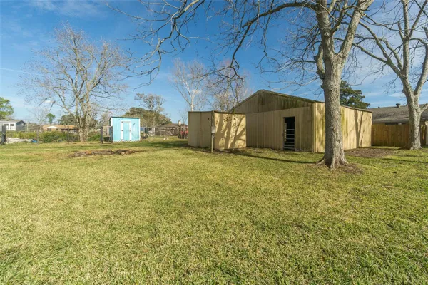 a house with huge green field in front of it