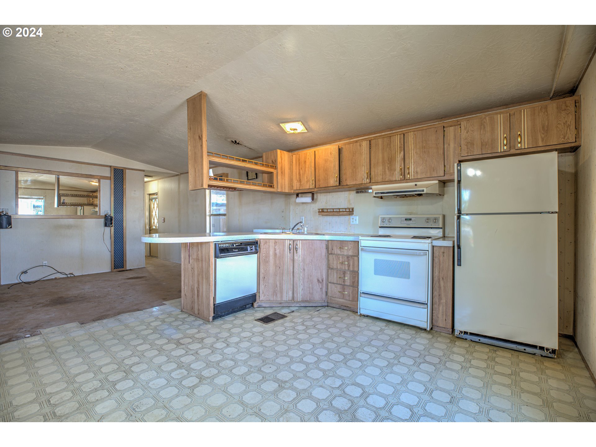 19605 River Road Gladstone, OR 97027 - Photo 11 of 21 a kitchen with kitchen island granite countertop a refrigerator a sink and a stove