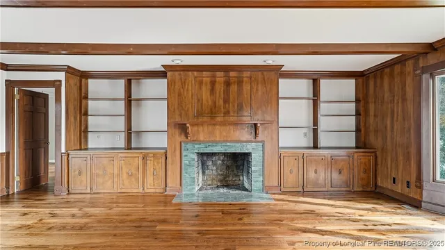 a view of a livingroom with an empty space and a fireplace