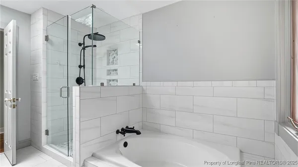 a bathroom with a bathtub and shower