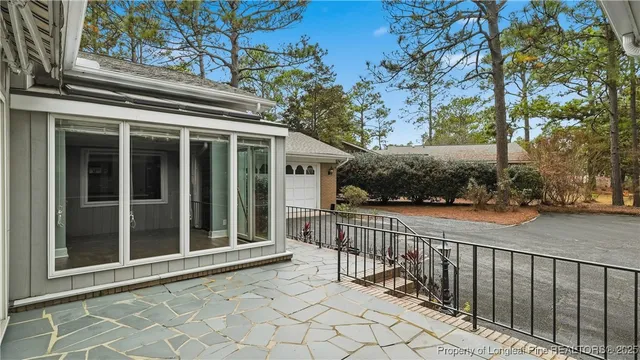 a view of a house with a large window and wooden fence