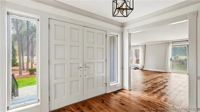 a view of a hallway view with wooden floor and door