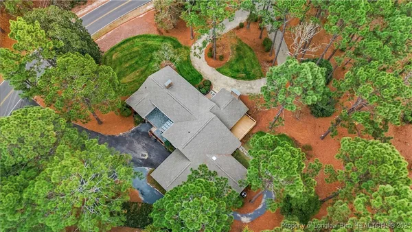 an aerial view of a house with garden space and street view
