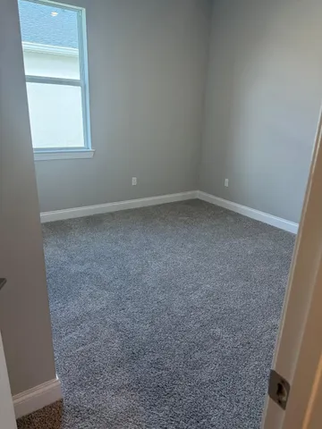 a spacious bathroom with a toilet sink and a mirror