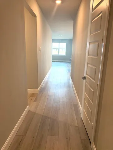 a kitchen with stainless steel appliances granite countertop a sink a stove a refrigerator with grey cabinets