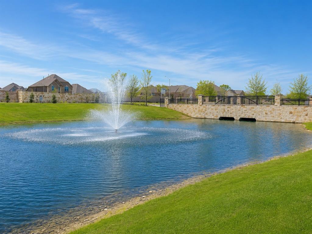 8235 Snapdragon Way Dallas, TX 75252 - Photo 26 of 29 Water feature with an active fountain, surrounded by manicured green spaces