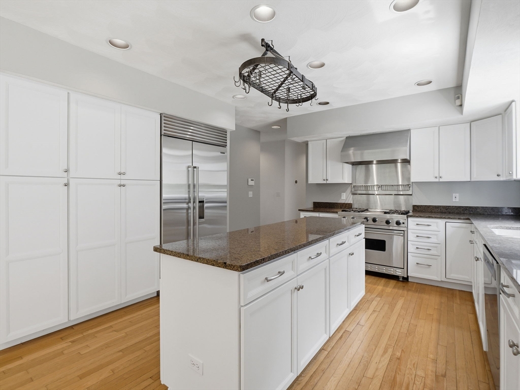 10 Hawk Ridge Road Andover, MA 01810 - Photo 7 of 32 a kitchen with stainless steel appliances granite countertop white cabinets a refrigerator a sink a stove a microwave and island