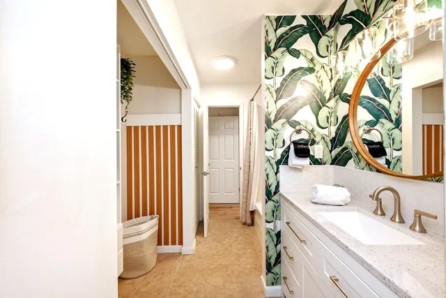 a bathroom with a granite countertop sink and a mirror
