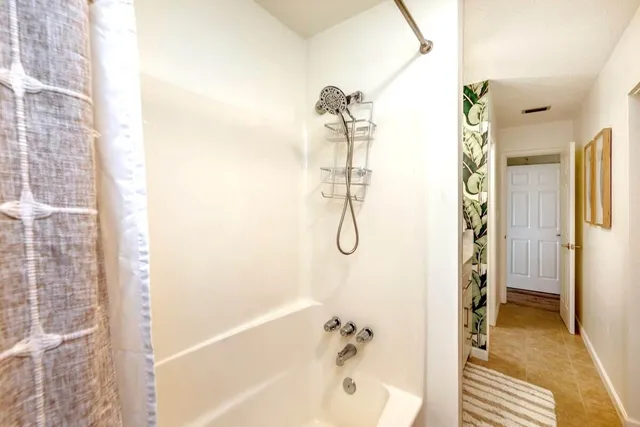 a bathroom with a bathtub and a shower