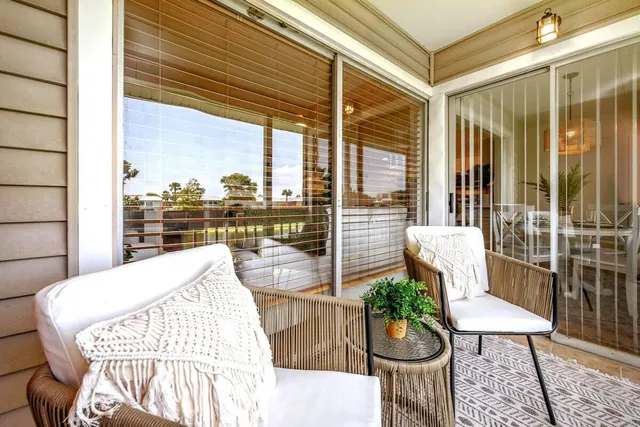 a balcony with furniture and a potted plant