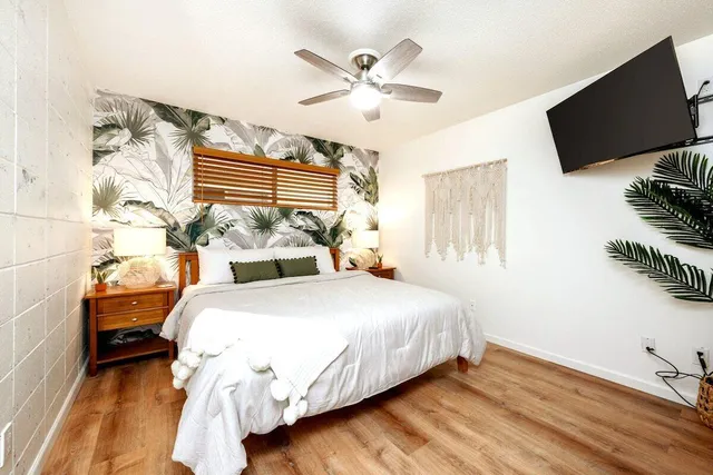 a bedroom with a bed and a flat screen tv