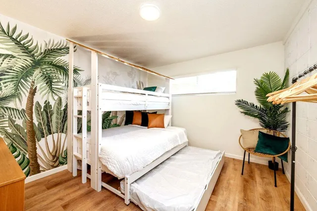 a bedroom with a bed and a potted plant