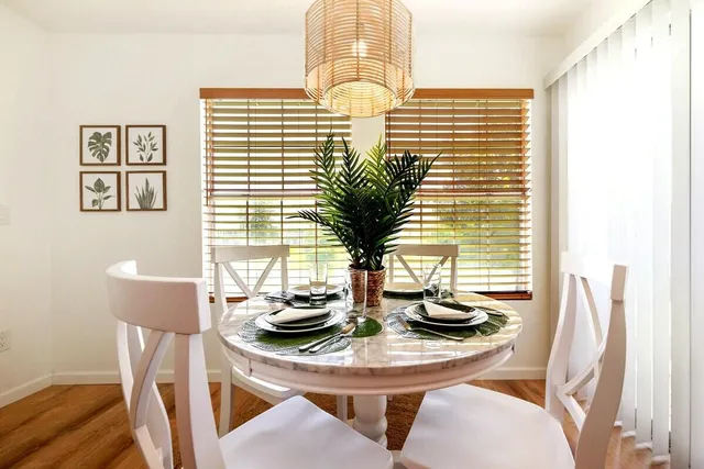 a view of a dining room with furniture and window