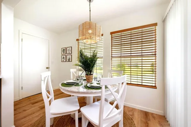 a dining room with furniture and window