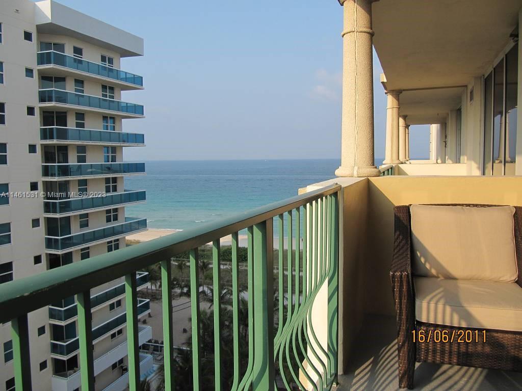 9195 Collins Avenue, Unit 613 Surfside, FL 33154 - Photo 12 of 13 a view of a balcony with wooden floor and fence