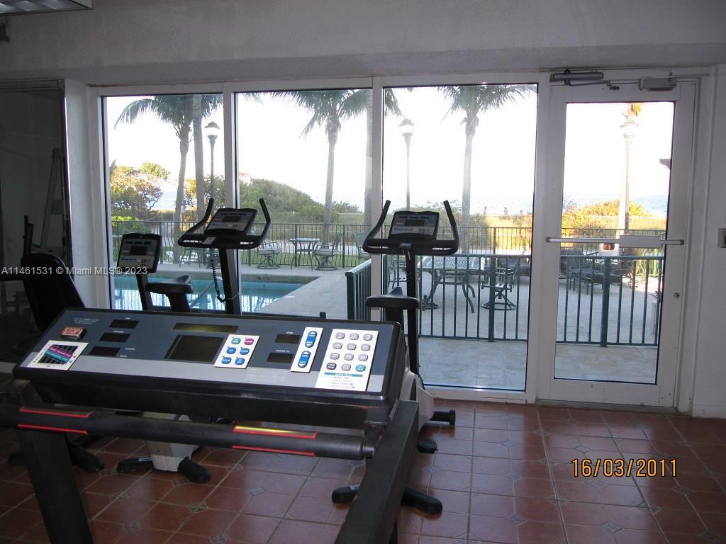 9195 Collins Avenue, Unit 613 Surfside, FL 33154 - Photo 4 of 13 a view of a living room with furniture and floor to ceiling window