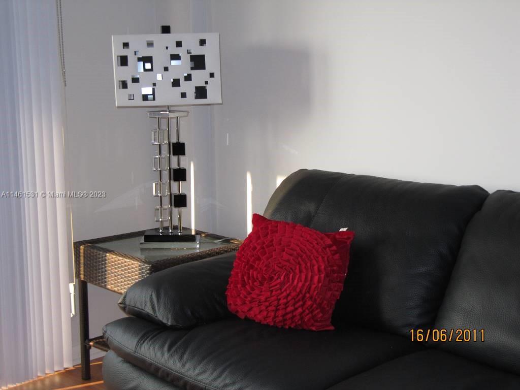 9195 Collins Avenue, Unit 613 Surfside, FL 33154 - Photo 10 of 13 a living room with furniture and decor