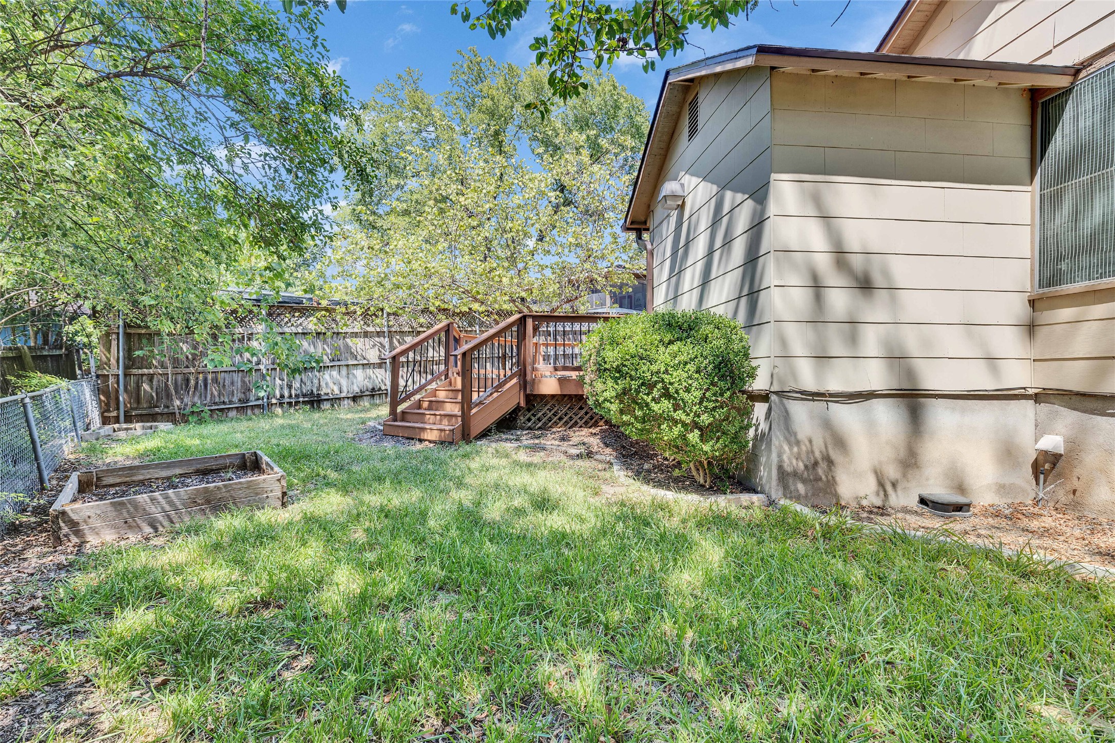 3810 Brookview Road Austin, TX 78722 - Photo 27 of 27 Mature trees frame a private lawn complete with an elevated wooden deck.
