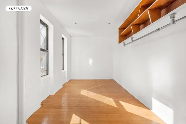 a kitchen with granite countertop white cabinets and refrigerator