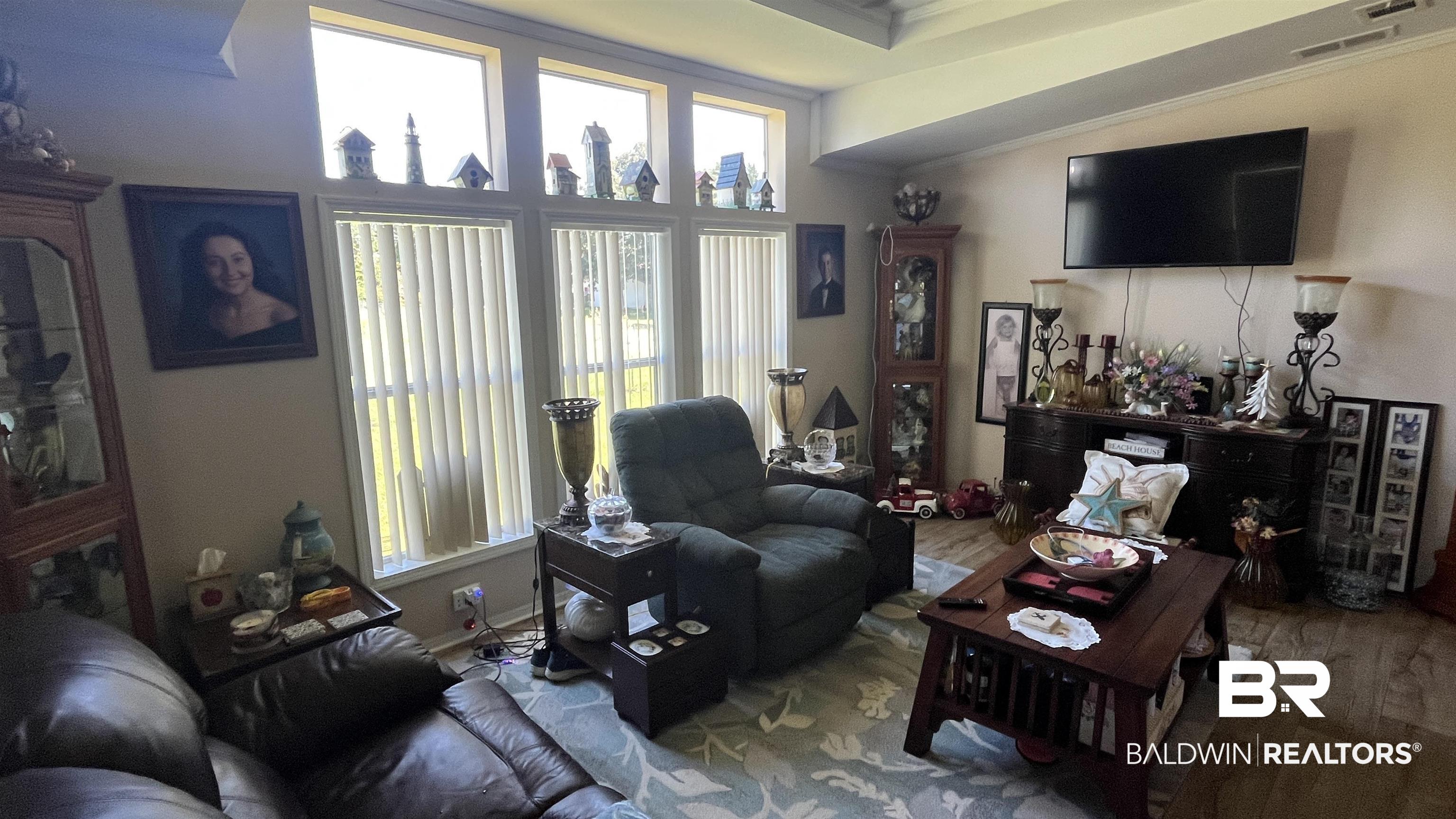 12932 Santa Piedro Street Lillian, AL 36549 - Photo 3 of 20 Living room featuring ornamental molding and wood finished floors