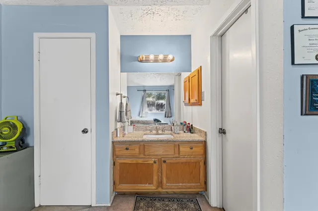 a bathroom with a sink mirror and vanity
