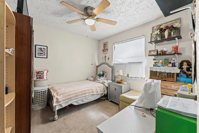 a bedroom with furniture and a large window