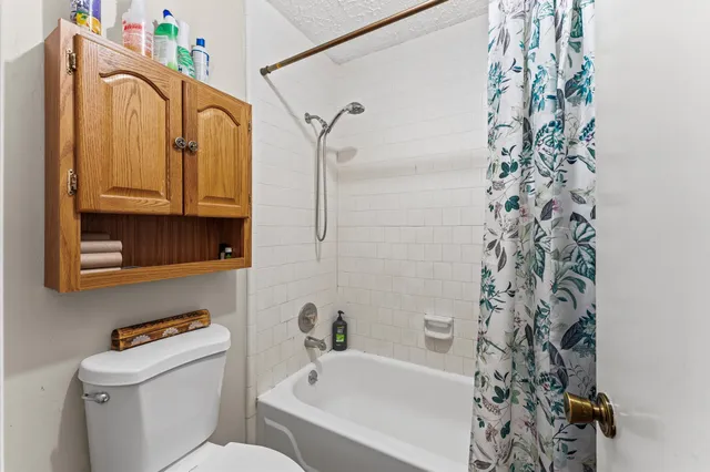 a bathroom with a bathtub sink and mirror