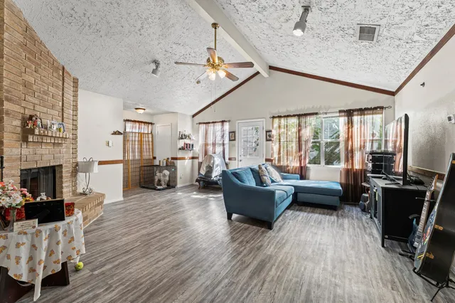 a living room with fireplace furniture and a wooden floor