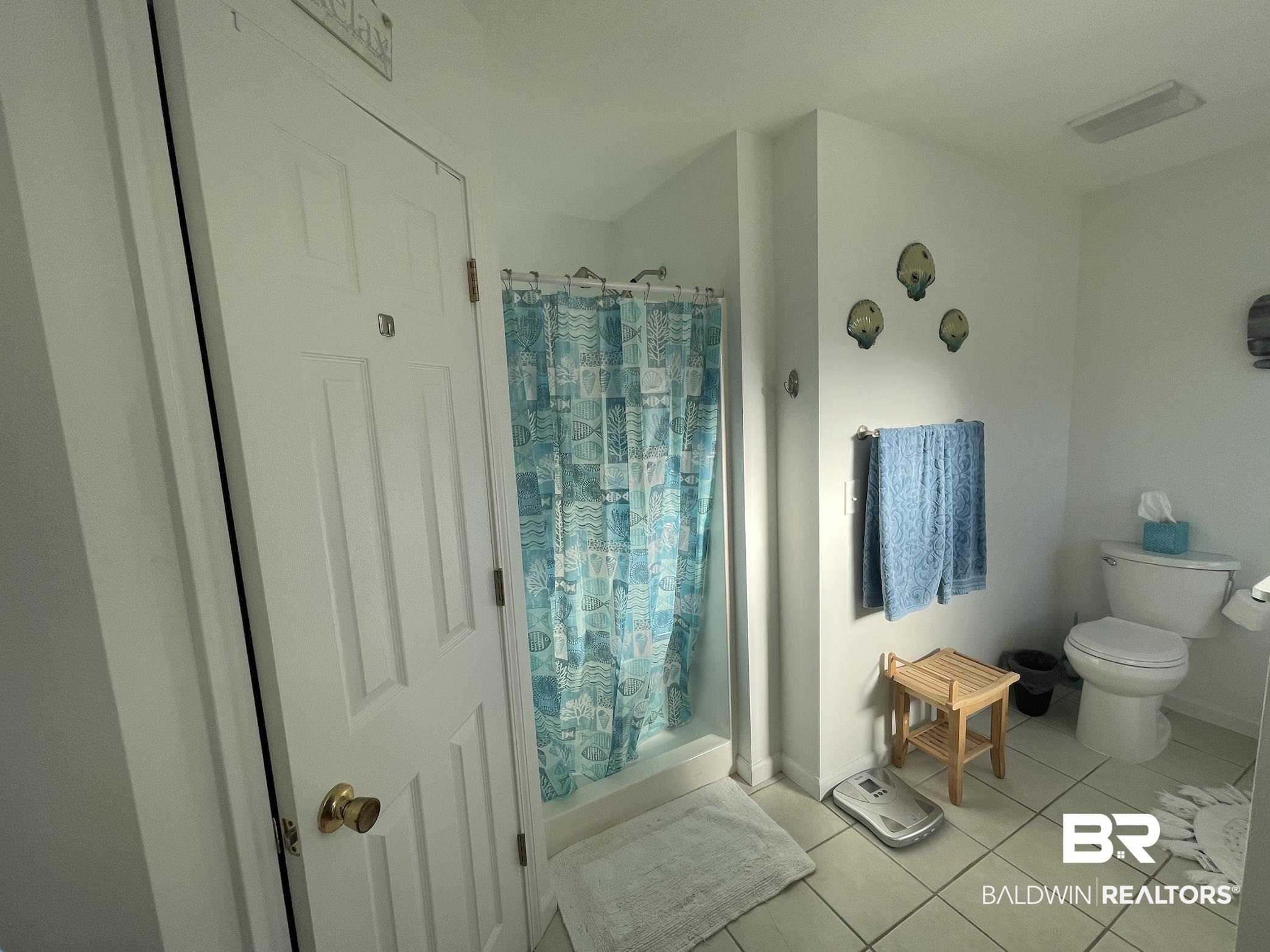17643 East View Loop Foley, AL 36535 - Photo 18 of 25 Bathroom featuring curtained shower, toilet, and tile patterned floors