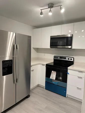 a kitchen with a refrigerator stove and microwave