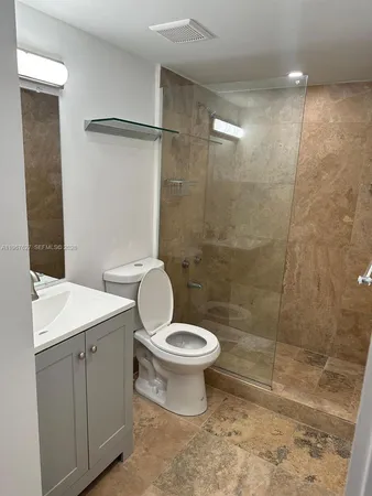 a bathroom with a toilet sink and a shower