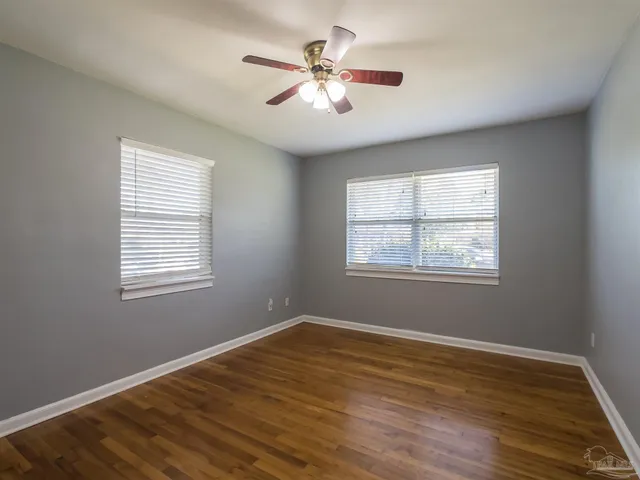 a view of a room with wooden floor and windows