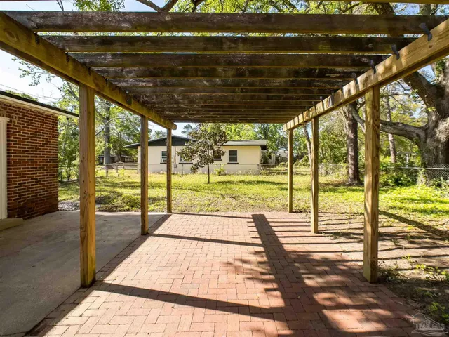 a view of a backyard with table and chairs