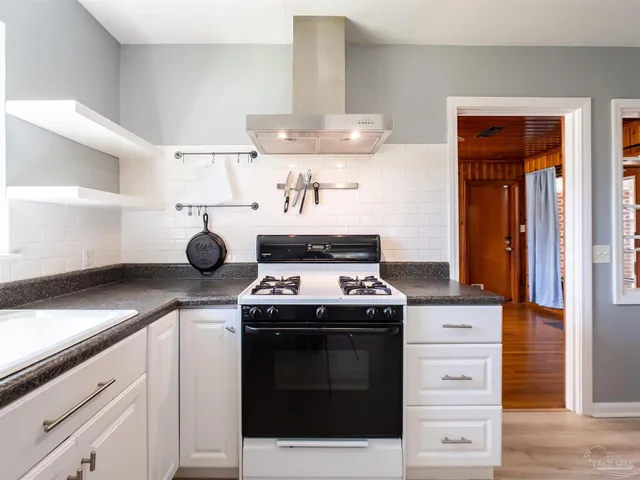 a kitchen with a stove and a sink