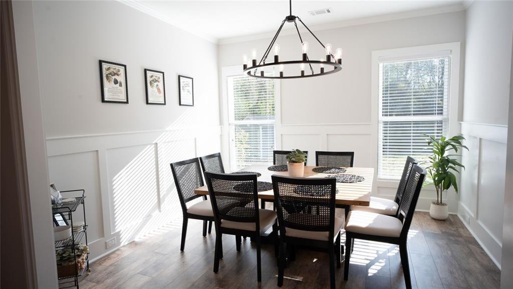 6165 Namon Wallace Road Cumming, GA 30028 - Photo 11 of 30 a view of a dining room with furniture window and wooden floor