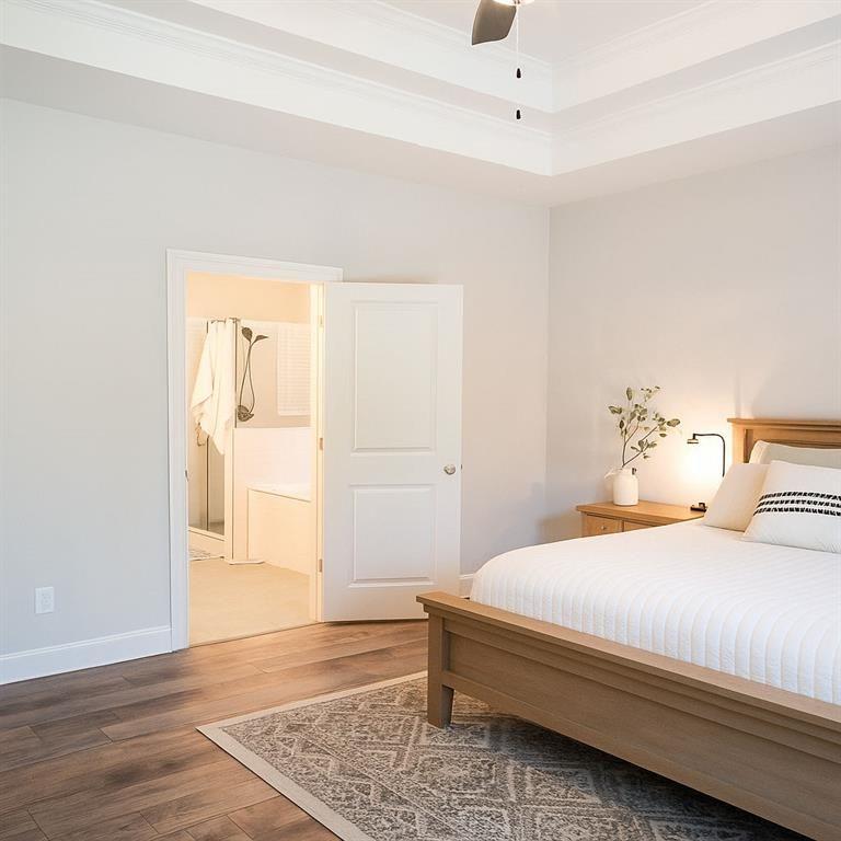 6165 Namon Wallace Road Cumming, GA 30028 - Photo 14 of 30 a bedroom with a bed and wooden floor