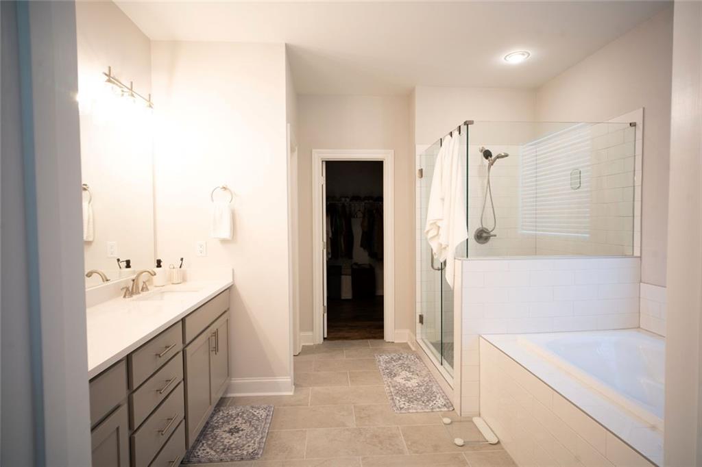 6165 Namon Wallace Road Cumming, GA 30028 - Photo 16 of 30 a bathroom with a sink a toilet and shower